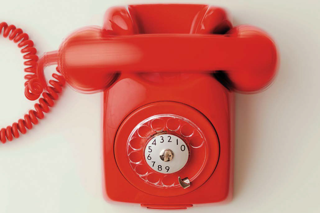 39038405 - top view of red vintage phone on white background